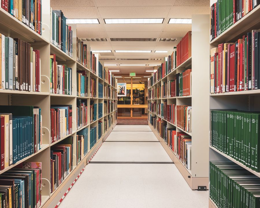 Rows of shelved volumes in a library